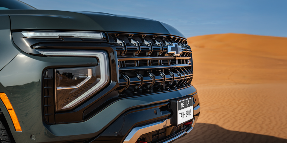 Close up Front Three-quarters View of front grille of 2025 Chevrolet Tahoe SUV's parked on sand