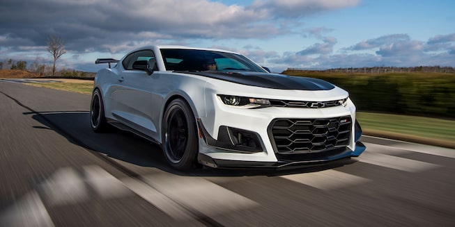 White Camaro Driving on a Countryside Road