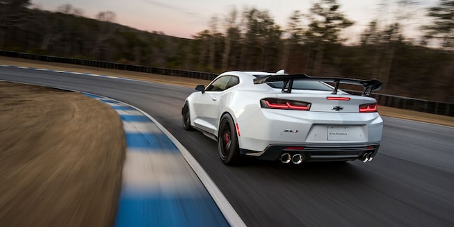 White Camaro Hugging a Corner on the Track