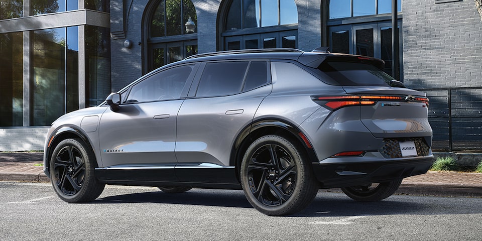 Side View of a Grey 2025 Equinox EV Next to a Building